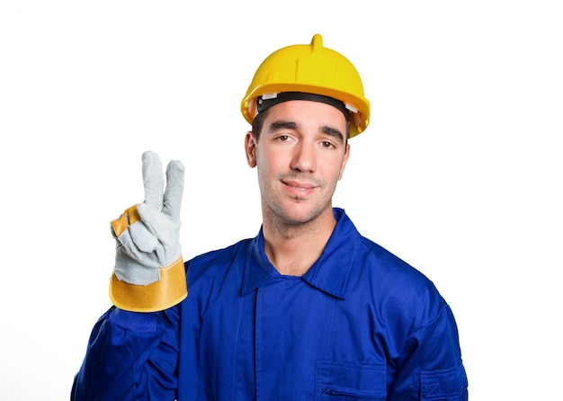 Premium Photo | Happy worker with victory gesture on white background