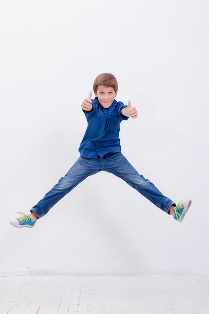 Free Photo | Happy young boy jumping on white background