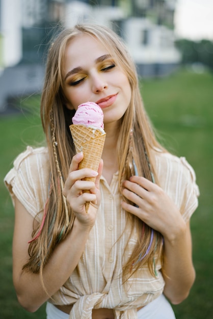 Premium Photo Happy Young Girl Holding Ice Cream And Enjoying A