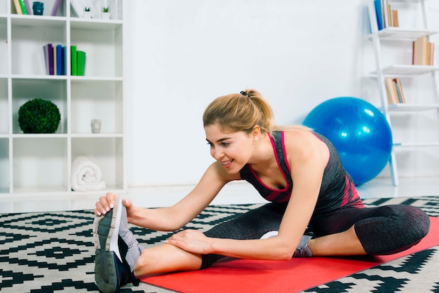 Free Photo Happy Young Woman Doing Some Warm Up Exercises At Home