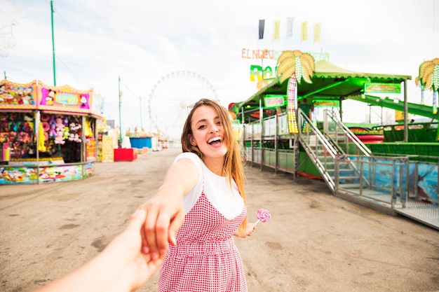 Free Photo | Happy young woman holding hand of her boyfriend at ...