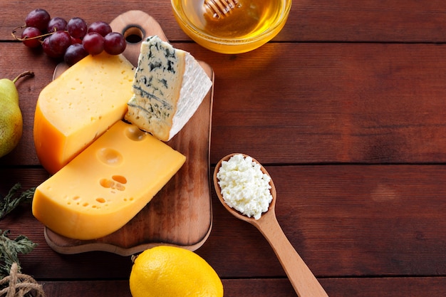 Hard Cheese Blue Cheese And Cottage Cheese On Wooden Board