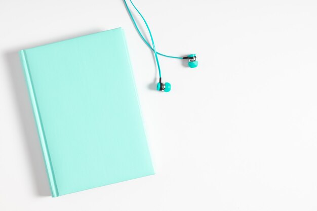  Headphones and book. audio book concept flat lay top view