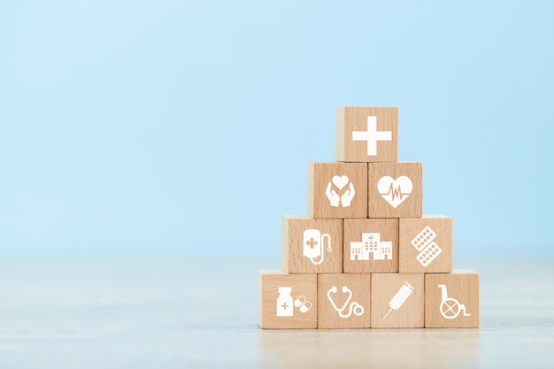 Premium Photo | Health insurance concept. wood block stacking with icon ...