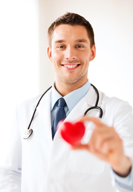  Healthcare and medical concept - male doctor with heart Premium Photo