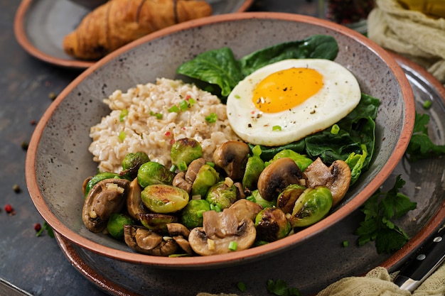 Premium Photo | Healthy breakfast. oat porridge, egg and salad of baked ...