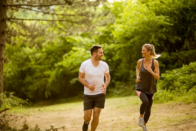 Premium Photo | Healthy fit and sportive couple running in nature