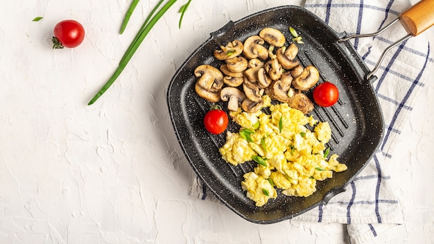 Premium Photo Healthy Scrambled Eggs With Mushrooms And Tomatoes For Breakfast On A Light Surface Top View