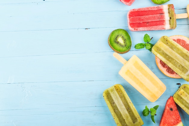 Premium Photo Healthy Whole Fruit Popsicles With Berries Kiwi Watermelon Cantaloupe On Wooden Vintage Table