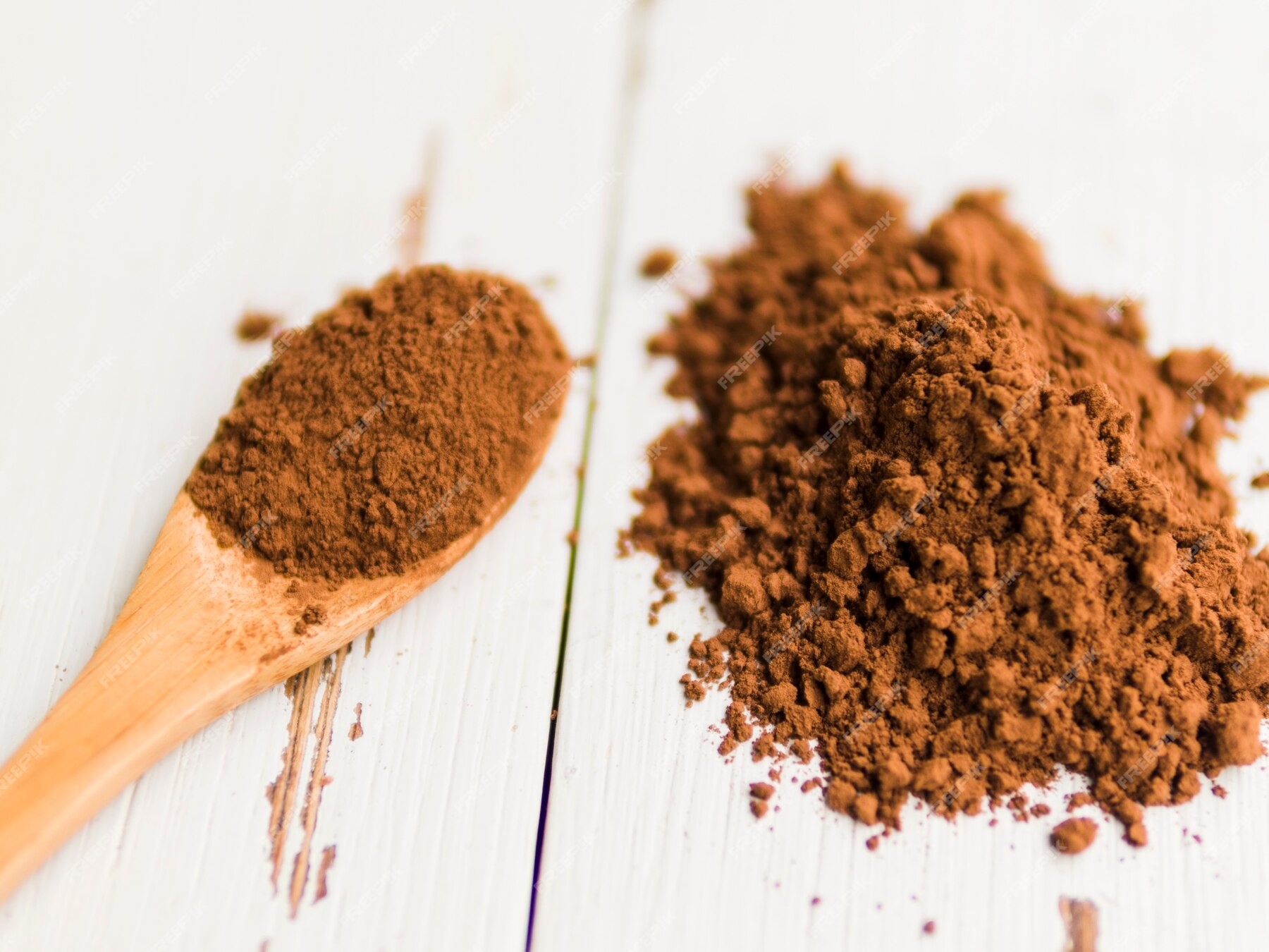 free-photo-heap-of-cocoa-powder-on-table-and-in-wooden-spoon