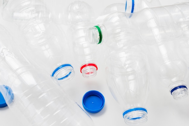 Heap of plastic bottles and caps on grey background | Free Photo