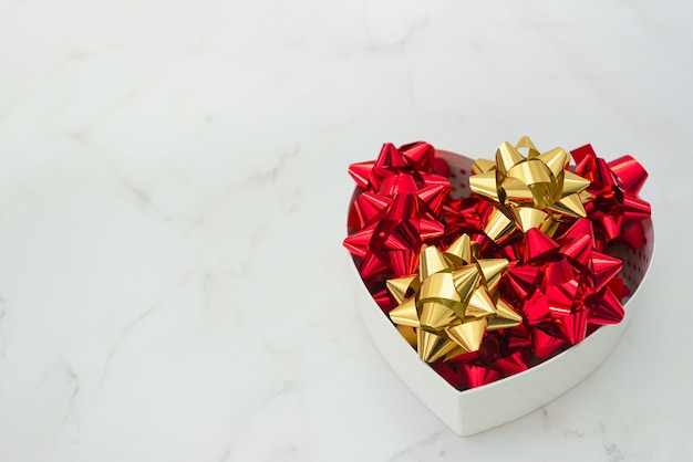 Heart Gift Box With Festive Bows Inside On White Marble