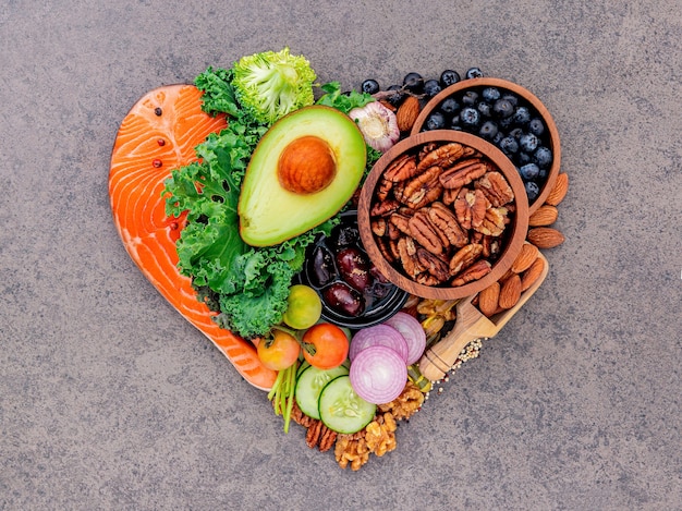 Heart shape of ketogenic low carbs diet concept on dark stone background. Premium Photo