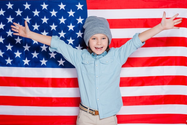 Premium Photo | Hello america! little boy in eyewear keeping arms ...