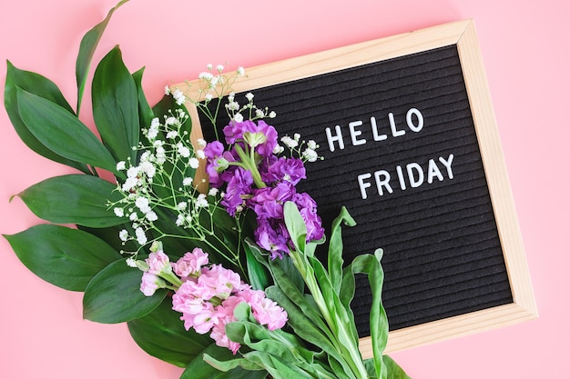 Premium Photo | Hello friday text on black letter board and bouquet ...