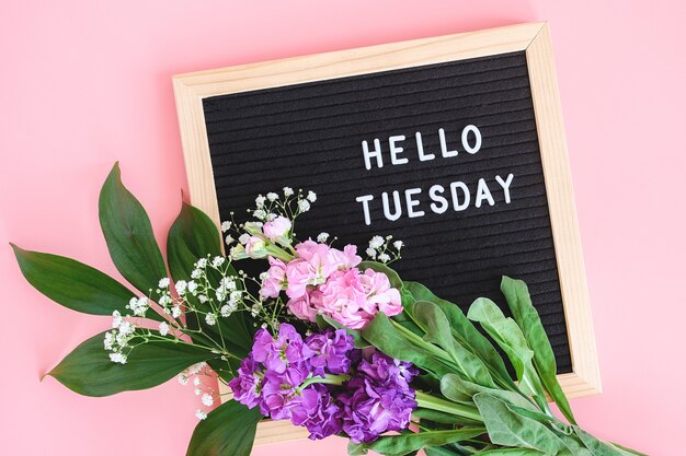 Premium Photo | Hello tuesday text on black letter board and bouquet ...