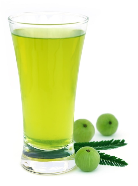 Premium Photo | Herbal amla juice with fresh fruits over white background