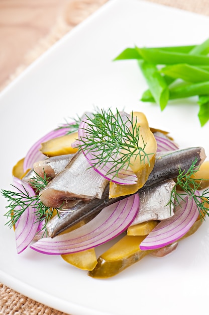 Free Photo | Herring salad with pickled cucumbers and onions