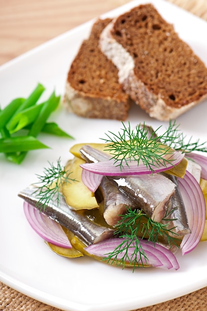 Free Photo | Herring salad with pickled cucumbers and onions