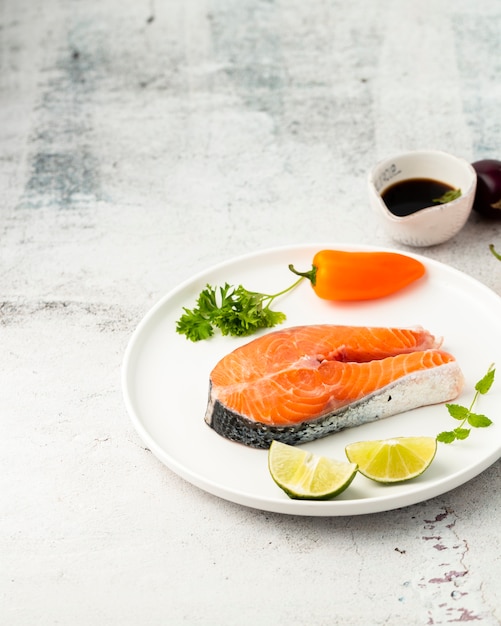 High angle arrangement with tasty fish and pepper Free Photo