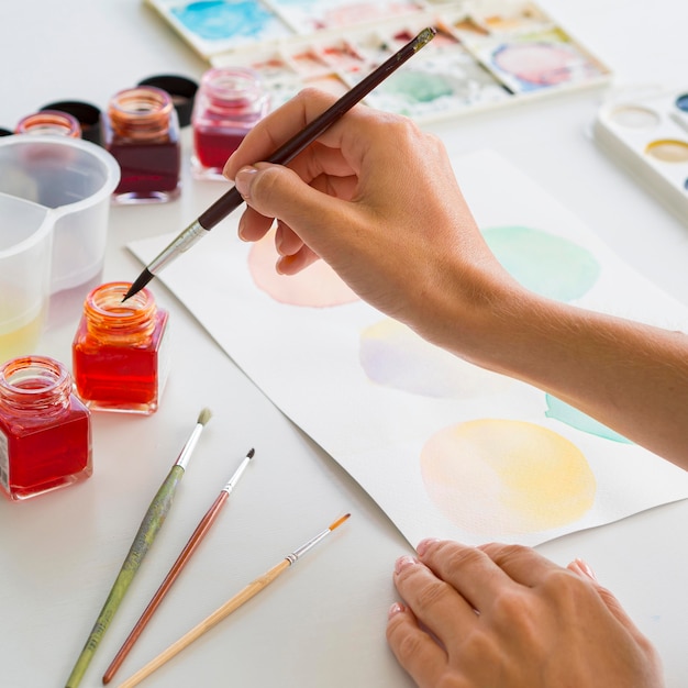 Free Photo | High angle of artist painting using watercolor