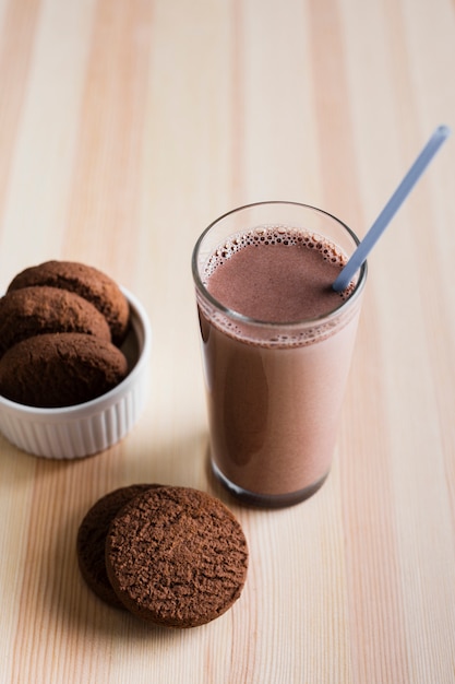 High angle chocolate milk with cookies Free Photo