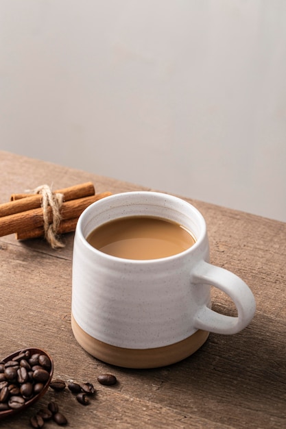 Free Photo | High angle of coffee mug with cinnamon sticks