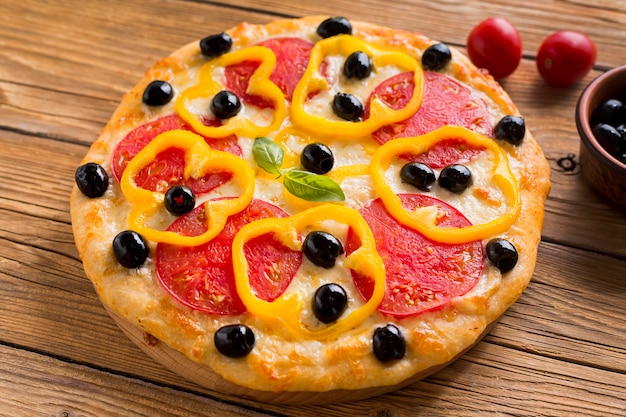 High angle of delicious pizza on wooden table Free Photo