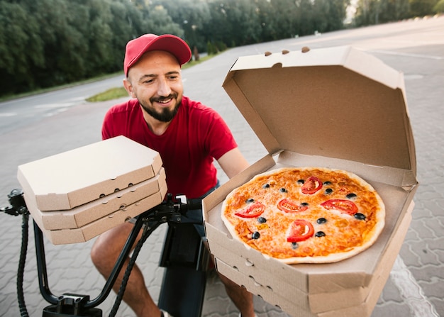 Download Free Photo High Angle Delivery Man With Opened Pizza Box PSD Mockup Templates