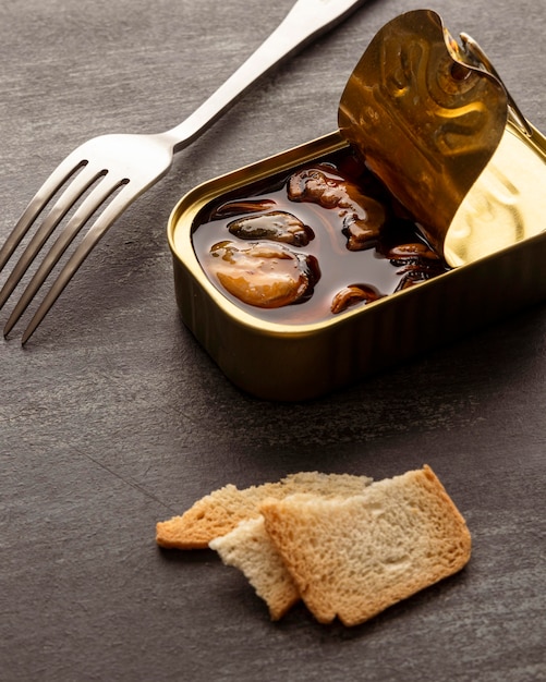 Free Photo | High angle mussels tin can with toast and fork