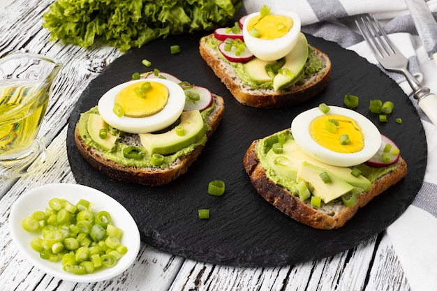 High angle of sandwiches on slate with egg and avocado Free Photo