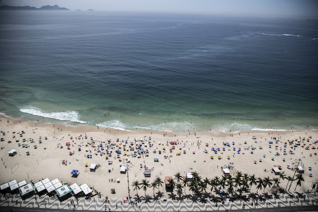 High angle shot of sugarloaf mountain and a beach near the blue sea in rio brazil Free Photo