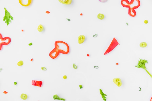 High angle view of colorful sliced vegetables on white background Free Photo