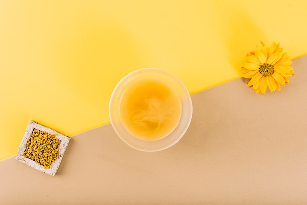 Premium Photo High Angle View Of Flowers Lemon Curd And Bee Pollen On Dual Colored Background