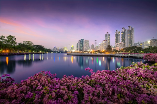 High business building behind the river in the park at beautiful night bangkok thailand Premium Photo