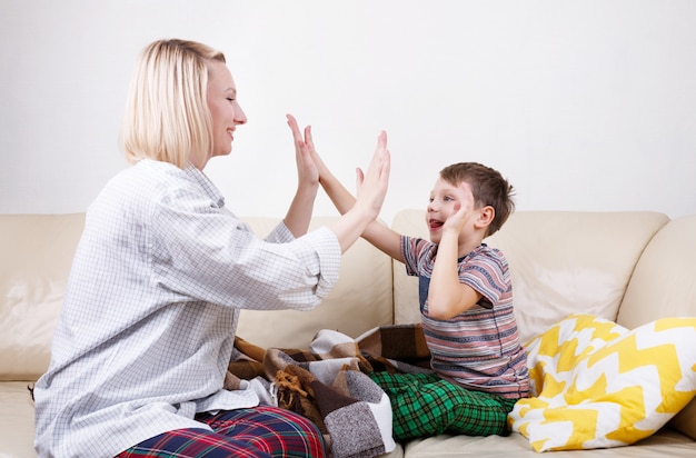 Premium Photo | High five between son and mom.