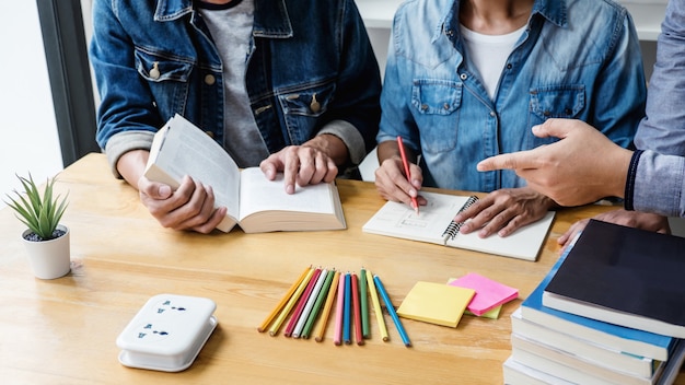 High School Tutor Or College Student Group Sitting At Desk In