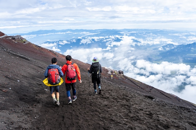 Premium Photo | Hikers climbing on yoshida trail on fuji mountain in ...