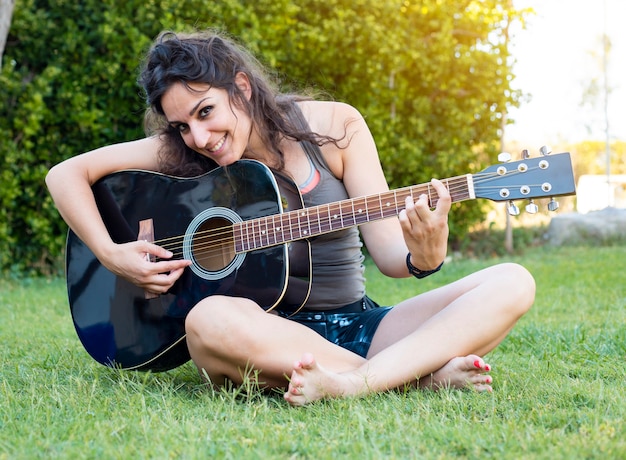 Premium Photo Hippie Woman Playing Guitar On Grass In Summer 