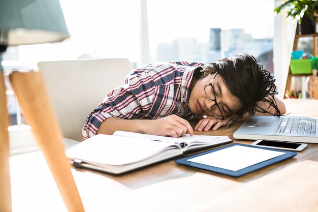 Premium Photo | Hipster businessman falling asleep on desk in office