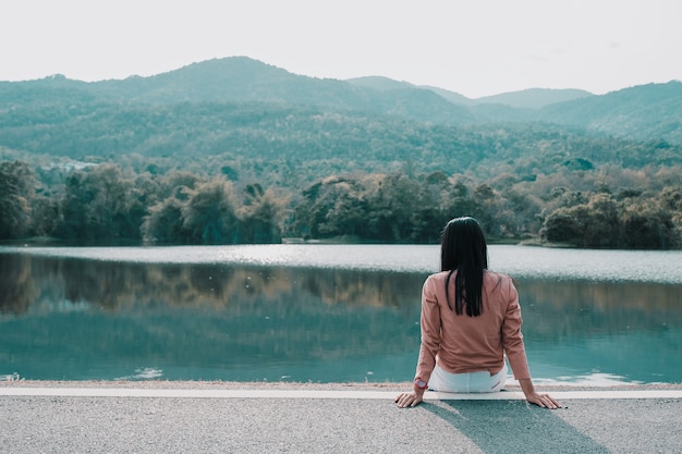 Premium Photo | Hipster woman sitting alone in the park on moutain ...