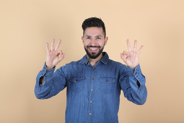 Premium Photo | Hispanic latino man makes ok gesture with his hands on ...