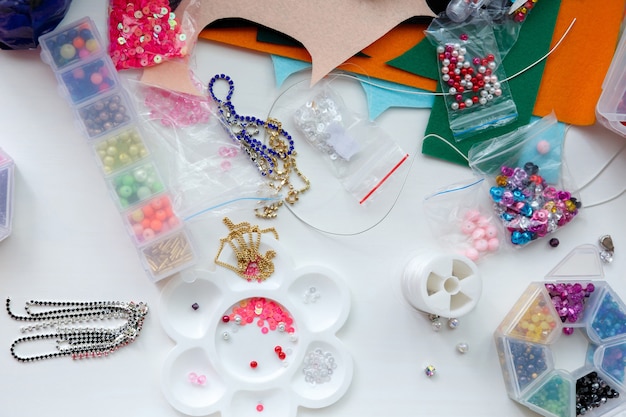 Premium Photo | Hobbies mess on the table and workspace for beadwork