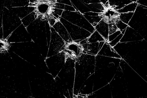 Premium Photo | Holes in the glass with cracks isolated on a black ...