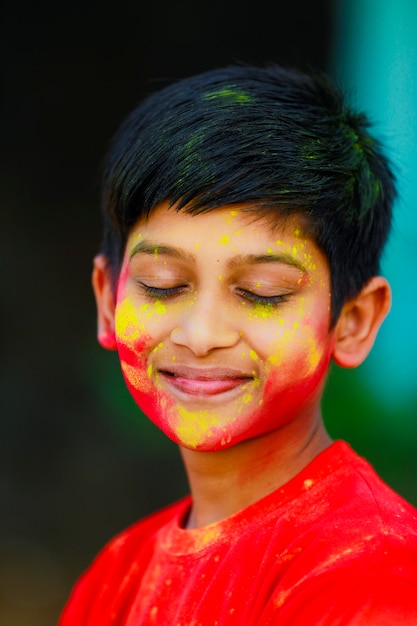 Premium Photo | Holi celebrations -indian little boy playing holi and