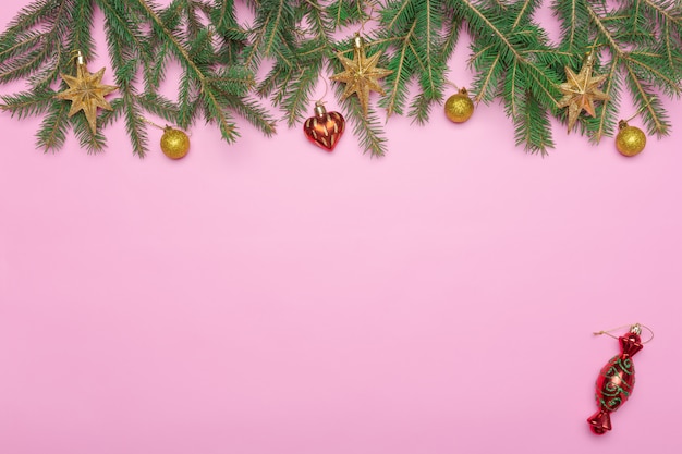 Premium Photo | Holiday frame of christmas decorations on pink ...