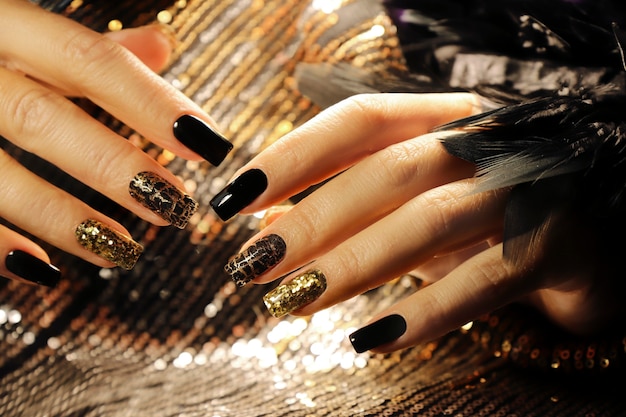 Premium Photo Holiday Manicure On Long Square Nails With Golden Sequins Black Shiny Nail Polish And Craquelure Matte Black Coating