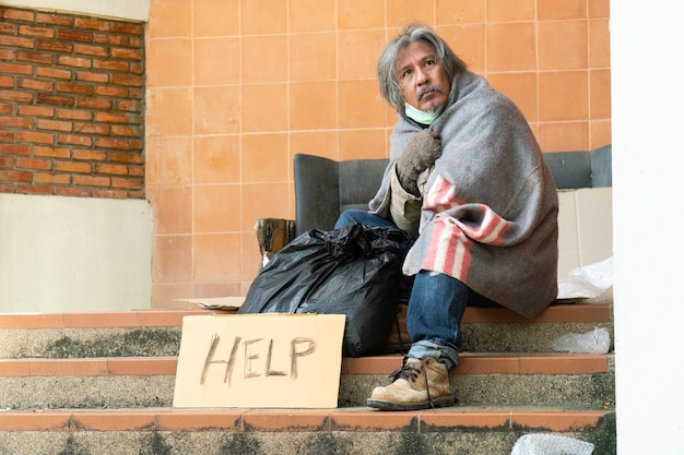 Premium Photo | Homeless Man Sitting On The Street.