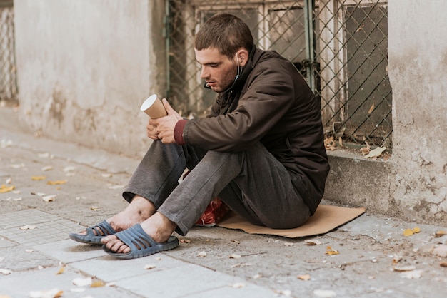 Free Photo | Homeless man on the street with cup