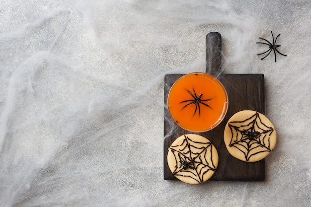 Homemade cookies for halloween, cookies with chocolate web and spiders Premium Photo